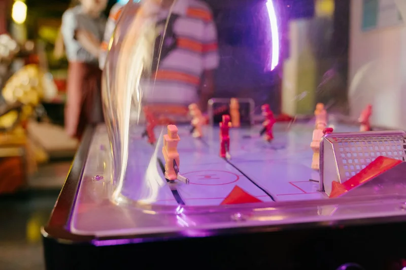 Close-up of bubble hockey arcade table under dome illustrating BGaming Plinko review