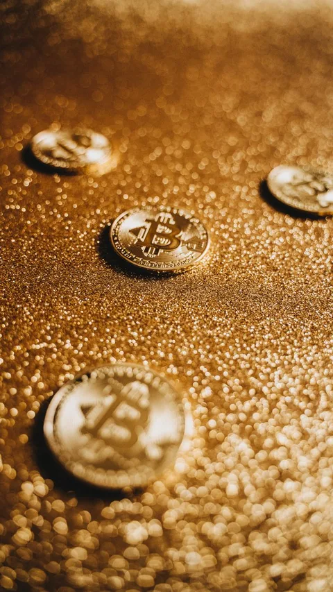 Gold Bitcoin coin on computer circuit