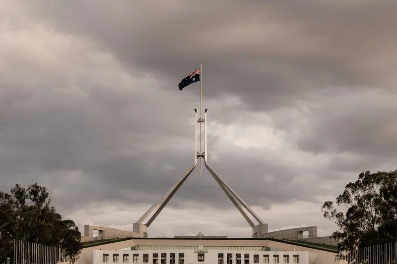 Parliament House in Canberra with Australian flag illustrating Plinko legality in Australia