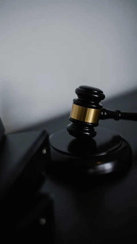 Wooden judge gavel on legal books