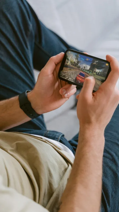 Hands holding smartphone horizontally gaming
