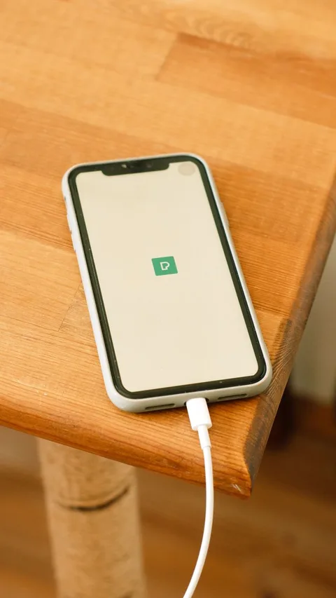 Phone charging on wooden coffee table