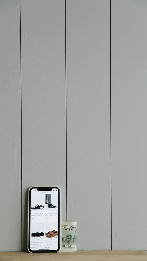 Australian dollar notes beside phone