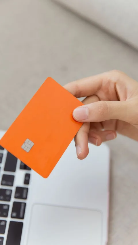 Credit card resting on modern laptop
