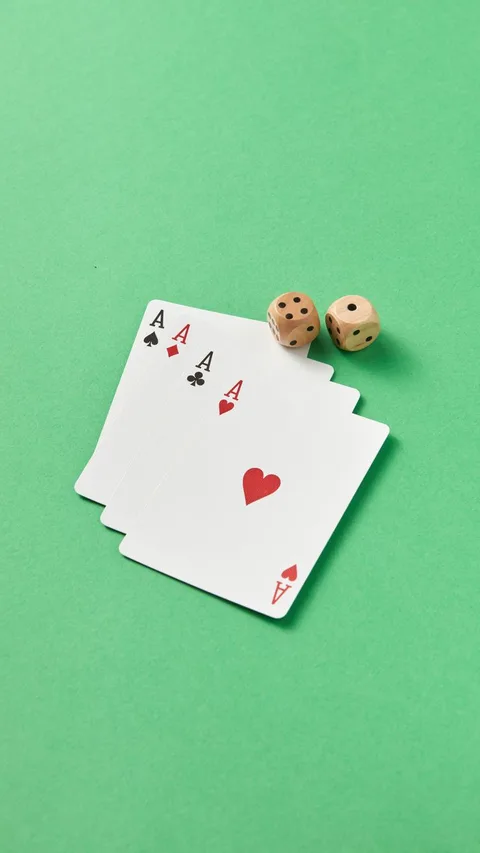 Pair of dice rolling on green felt