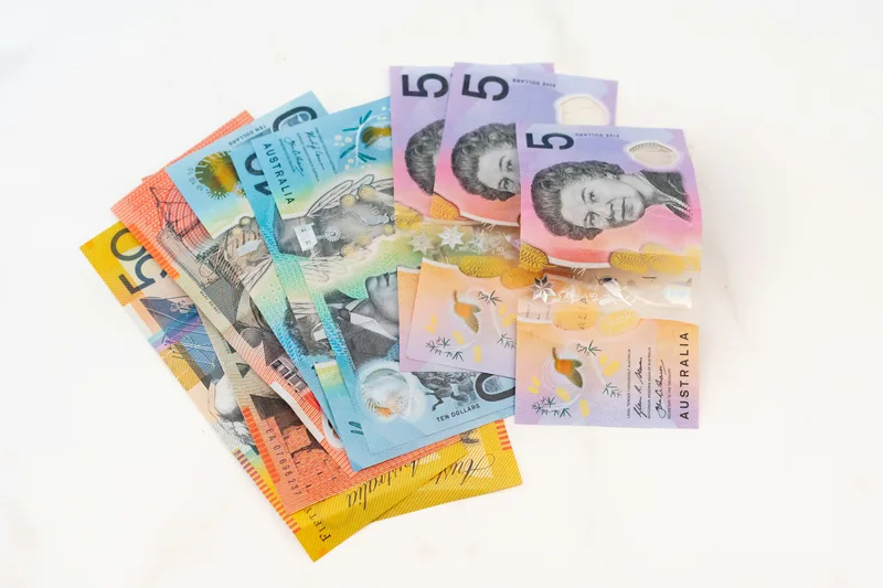 Australian dollar notes fanned out illustrating Plinko bankroll management