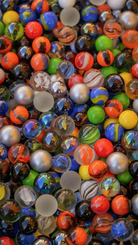 Vibrant glass marbles on flat surface